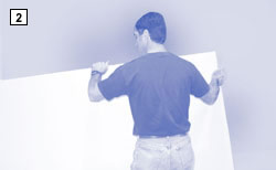 photo of man lifting drywall