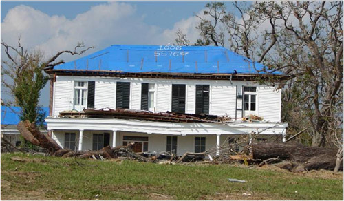 Photo of damaged roof with blue tarping