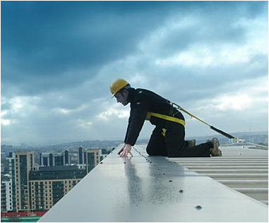 personal fall restraint- man with the PSA, looking over the edge of a building