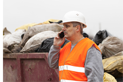 Man in orange safety gear on the cell phone