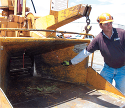 man in protective gear standing next to machinery