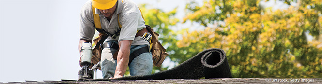 Photo of worker on roof.